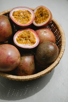 pexels-photo-5946097-5946097 Close-up of ripe passion fruits in a wicker basket on a light background.